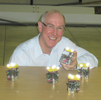 Professor Alan Winfield with a group of miniature 'e-puck' robots