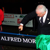 Alfred Morris christens one of the new boats with champagne